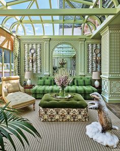 a living room with green couches and chairs in it's centerpieces