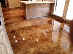 a kitchen that is being remodeled with marble flooring and cabinets in the back ground