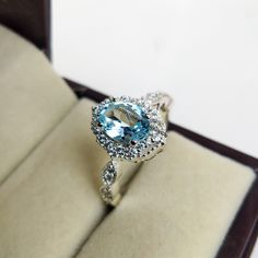 "Natural Blue topaz Ring For Women, Engagement Ring, Anniversary Ring, Best Ring For her, Jewelry for Girls, Proposal Ring, Promise Ring Specifications :- ❥ Stone - Natural Sky Blue Topaz ❥ Stone Size - 6x8mm  ❥ Cut Type - Oval ❥ Side Stones- Simulated diamonds Cz ❥ Ring Size: I offer more than one (Contact us if your ring size is not available in the listing) ❥ Color: Silver, Gold, Rose Gold, White Gold or Black Rhodium ❥ Material : 925 Sterling Silver, 14K/18K/22K Solid Gold --> ❥ Makes a Wonderful Gift for your Girlfriend, Wife, Mother and Friend or Simply an Excellent Addition to Your Jewelry Collection -->IF YOU WANT CUSTOM ENGRAVING ON YOUR RING VISIT OUR LISTING HERE: It's Only 2 USD https://www.etsy.com/listing/1436332485/custom-engaraving - -Here's a link to my HOMEPAGE: Johrifine Topaz Ring With Halo Design Cubic Zirconia For Gifts, Cubic Zirconia Topaz Ring With Halo Design As Gift, Cubic Zirconia Halo Topaz Ring As A Gift, Blue Topaz Cubic Zirconia Promise Ring, Blue Cubic Zirconia Topaz Promise Ring, Topaz Crystal Ring With Halo Setting Gift, Light Blue Diamond Ring With Accent Stones For Wedding, Sapphire Crystal Ring With Halo Setting For Promise, Sapphire Crystal Promise Ring With Halo Setting