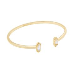 Looking for a pop of sparkle to add to your wrist stack? Meet the Emma Cuff Bracelet, aka your new style essential. Two elongated stones bookend this adjustable metal cuff you can fit to your wrist perfectly. On-trend and oh-so-cute, you'll style this bracelet time and time again. Designer, founder, and philanthropist Kendra Scott started her company in 2002, just three months after her first son was born. Her commitment to innovation, quality, customer service, and detail has taken her from a s Kendra Scott Bangle, Old Money Bracelet Stack, Kendra Scott Cuff Bracelet, Gold Bracelet Stack, Gold Bracelet Bangle, Wrist Stack, Kendra Scott Bracelet, Brass Cuff Bracelet, Gold Cuff Bracelet