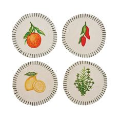 four plates with different designs on them, one has oranges and the other has peppers