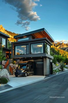 a black van parked in front of a house on the side of a mountain road