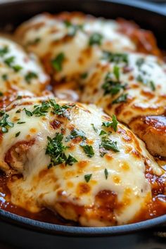 chicken parmesan in a skillet with cheese and herbs on top, ready to be eaten