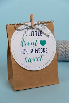 a little treat for someone sweet tag on a brown paper bag with twine around it