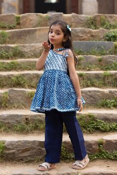 "Perfect for summer weddings and festivals this lehengha and top (set of 2) is an eye turner. Shouting with oodles of comfort during the festivities this cotton peplum suit is going to make your little one feel like herself while enjoying the festive season. Kurta - Blue leheriya with silver top, off shoulder look with tie ups on 1 shoulder. Payjama - Navy blue payjama makes it a comfy wear for your little ones as it comes with elasticated waist with drawstring for easy wear.   Fabric - Cotton C Bollywood Style Pant Set With Dupatta For Summer, Bollywood Style Summer Pant Set With Dupatta, Festive Sleeveless Bandhani Print Set, Festive Sleeveless Sets With Bandhani Print, Fitted Sleeveless Cotton Palazzo Set, Bollywood Style Festive Pant Set For Spring, Bollywood Style Festive Spring Pant Set, Cotton Party Dresses For Eid, Festive Sleeveless Cotton Traditional Wear