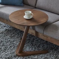 Introducing the Covis Side Table - the perfect solution for those who enjoy lounging in comfort and style. This modern and sleek solid wood round table measures 50cm in diameter and is designed to slide easily under your sofa, offering a convenient surface for holding snacks and beverages without taking up too much space. Crafted from high-quality oak wood, this table is sturdy and durable, featuring v-shaped legs that keep it from wobbling or ti Bedside Table Design, Solid Wood Side Table, Small Bedside Table, Nordic Living Room, Wooden Side Table, Side Coffee Table, Wooden Sofa, Sofa Side Table