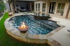 a pool with a fire pit in the middle