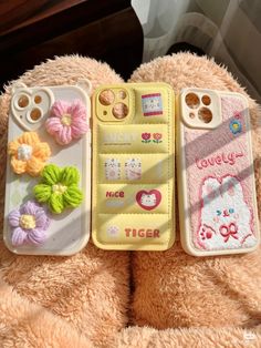 two cell phones are sitting next to each other on a teddy bear's lap