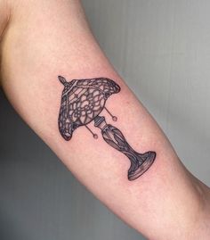 a tattoo on the arm of a person with a fish in it's mouth