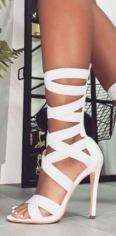 Trendy White High Heel Lace-up Sandals, Trendy White Lace-up Sandals For Party, White High Heel Strappy Heels, Chic Strapped Summer Heels, White Strappy Sandals For Party, White Ankle Strap Sandals With Wrapped Heel, White High Heel Lace-up Sandals, Trendy White Ankle Strap Lace-up Sandals, White Party Sandals With Straps