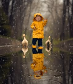 a little boy that is standing in the rain with some ducks and ducklings behind him