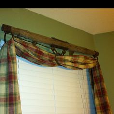 a window curtain with a wooden rod hanging from it's side