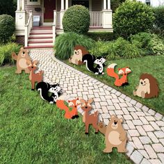 an outdoor lawn decoration with squirrels and raccoons in front of a house