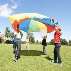 several people holding up a large colorful kite