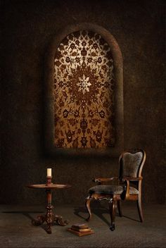 a chair and table in front of a wall with an ornate design on it's side