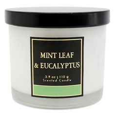 a white candle with black lid that says mint leaf and eucalyptus