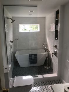 a bath room with a tub a toilet and a sink