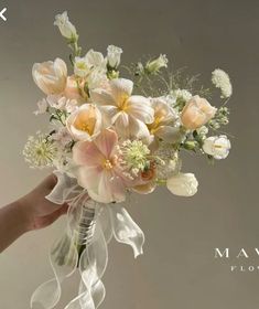 a person holding a bouquet of flowers in their hand with the words mauve above it