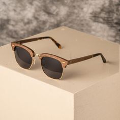 Experience vintage charm with a modern twist in the Biarritz sunglasses. With their clubmaster shape, they evoke a longing for beachside drives. The sleek walnut wood frame beautifully complements the rounded lenses, exuding effortless cool for all genders. Crafted with natural or recycled materials, these unisex sunglasses prioritize sustainability without compromising style. Embrace the sun's warmth while honoring the environment, knowing each wear supports eco-conscious fashion. * Each frame Uk Design, Wooden Watches For Men, Wooden Sunglasses, Buy Watches, Wooden Watch, Conscious Fashion, Sunglasses For Men, Optical Frames, Unisex Sunglasses