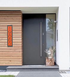 a modern entrance with wooden slats on the side