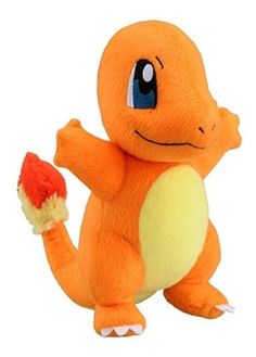 an orange stuffed animal with blue eyes holding a red and yellow object in it's hand