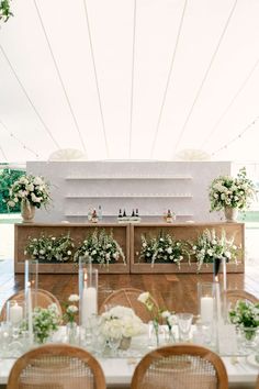 an outdoor wedding setup with flowers and candles