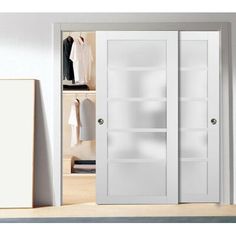 an open closet with white doors and shelves