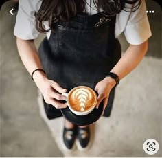 a woman holding a cup of coffee in her hands