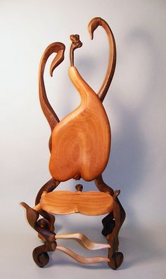 a sculpture of a bird sitting on top of a chair