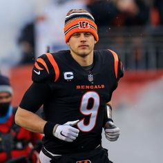 a football player wearing an orange and black uniform