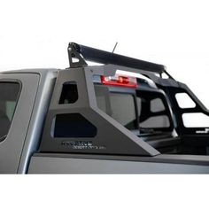 the back end of a pickup truck with its lights on and an extended roof rack