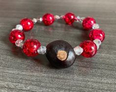 "Ohio State Buckeyes Bracelet made with real Ohio grown buckeye! Bracelet made with durable clear stretchy cord. One size fits most. 7.25-7.5\" If you need a specific length, please include a buyers note with your order so I can accommodate that request! Buckeyes Bracelet, Ohio State Jewelry, Ohio State Fan Gift, Ohio Christmas, Real Buckeye Bracelet, Womens Ohio State Bracelet" Ohio State Bracelet, Ohio State Gifts, Osu Buckeyes Football