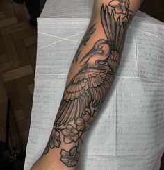 a person with a bird tattoo on their arm