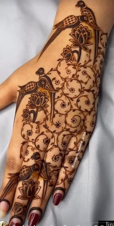 a woman's hand is decorated with hennap and intricate designs on it