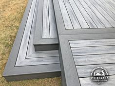 two wooden benches sitting on top of a grass covered field