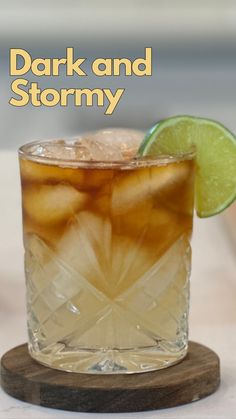 dark and stormy cocktail with lime garnish on the rim