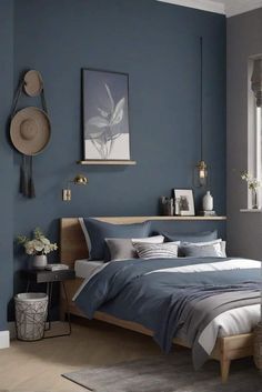 a bedroom painted in blue and grey with a wooden headboard, bedding, rugs and pictures on the wall