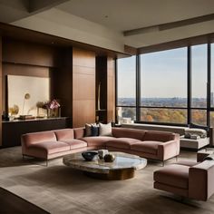 a living room filled with lots of furniture and large windows overlooking the cityscape