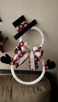 a christmas decoration made out of fabric and bows on the headbands is displayed in front of a wall