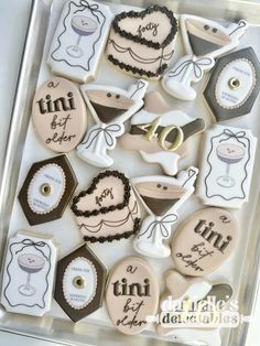 decorated cookies in the shape of baby's first birthdays are displayed on a tray