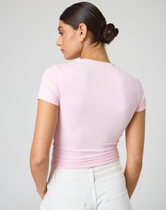 This jersey style t-shirt features supersoft material, short sleeves and a long line length. Athleisure Stretch T-shirt For Spring, Minimal Stretch Spring Tops In Athleisure Style, Athleisure Short Sleeve Tops For Summer, Casual Short Sleeve Crew Neck Top In Elastane, Trendy Fitted Elastane T-shirt, Basic Stretch Tops With Shirttail Hem, Pink Fitted Top With Short Sleeves, Pink Fitted Short Sleeve Top, Trendy Solid Color Elastane T-shirt