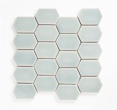 white hexagonal tiles are arranged on the wall