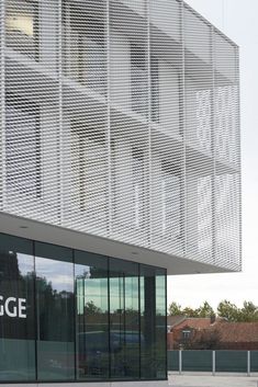 a large building with many windows on top of it's sides and the words college written in white