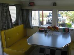 a kitchen table with two chairs in front of it and a checkered rug on the floor