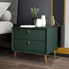 a nightstand with two vases on it next to a bed