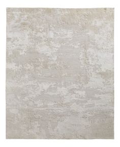 a white rug with an abstract design on the top and bottom, in shades of beige