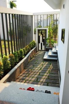 an open door leading into a small courtyard with steps and plants on the side walk