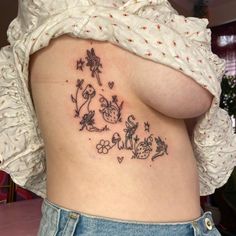 a woman's back with tattoos on her stomach