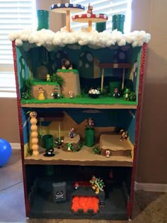 this is a toy shelf with mario's house on top and other toys in it