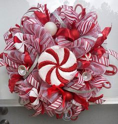 a red and white christmas wreath with candy canes